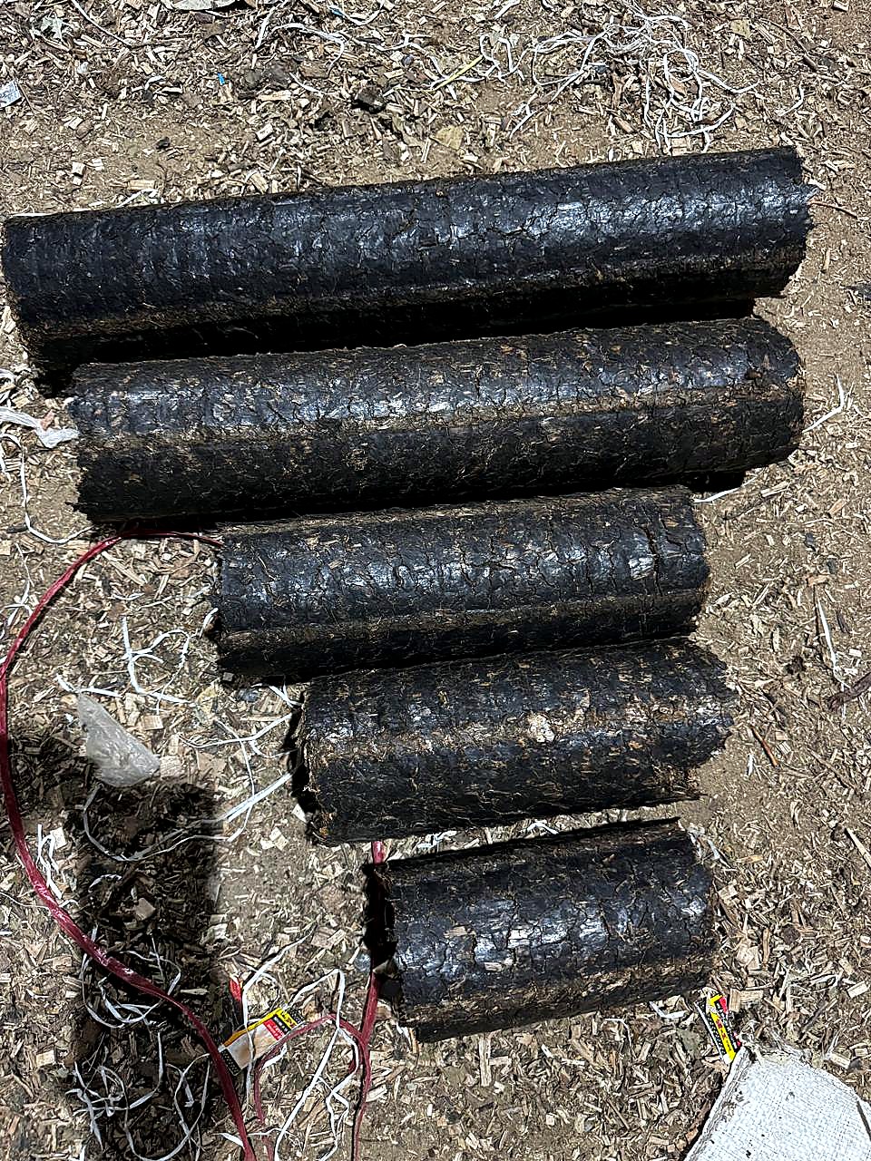 Finished dark biomass briquettes